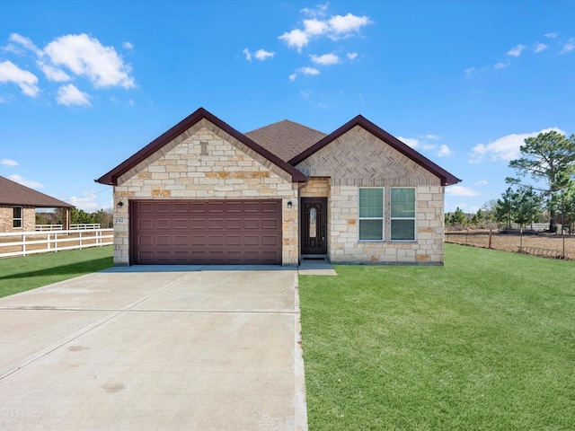 view of front of home featuring a garage and a front yard