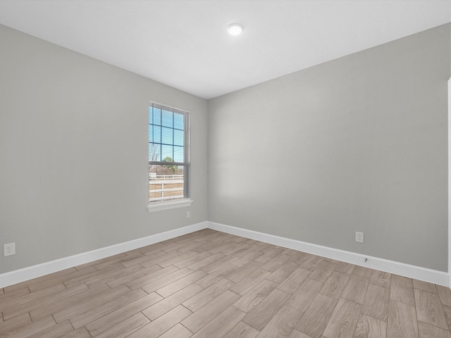 spare room featuring light wood-type flooring