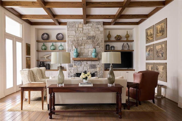 living room featuring coffered ceiling, beam ceiling, wood-type flooring, and built in features