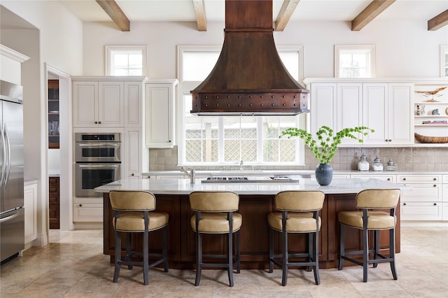 kitchen featuring a kitchen island, white cabinets, and appliances with stainless steel finishes