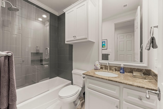 full bathroom featuring vanity, crown molding, tiled shower / bath combo, and toilet