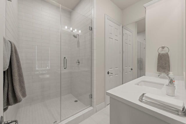 bathroom with vanity, tile patterned flooring, and a shower with shower door