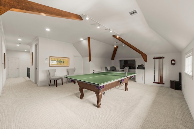 recreation room with rail lighting, vaulted ceiling with beams, and light colored carpet