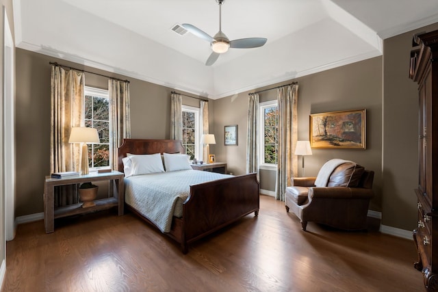 bedroom with dark hardwood / wood-style flooring, multiple windows, and ceiling fan