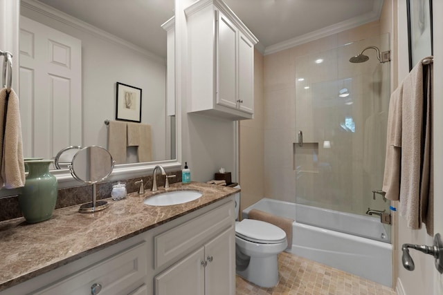 full bathroom featuring crown molding, toilet, vanity, and tiled shower / bath