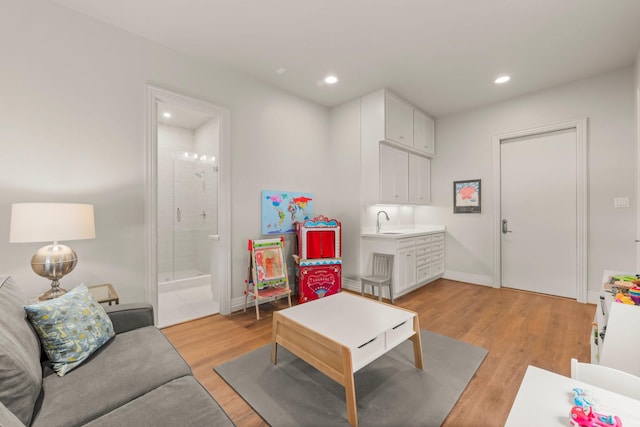 living room featuring sink and light wood-type flooring