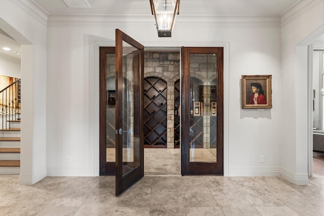 wine area featuring french doors and ornamental molding