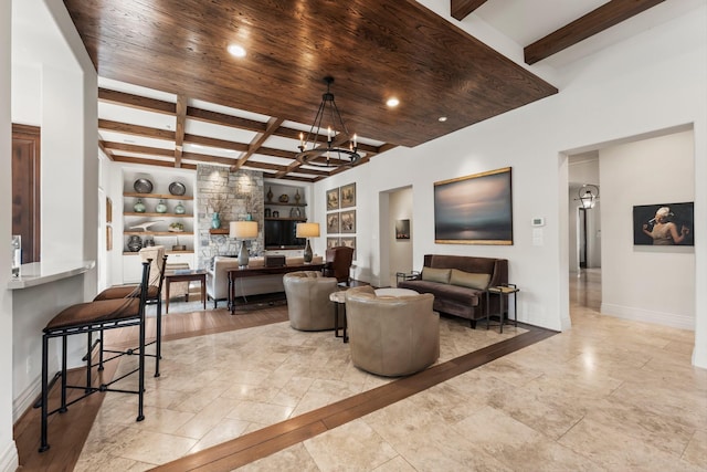 living room featuring beamed ceiling, wood ceiling, built in features, and a notable chandelier