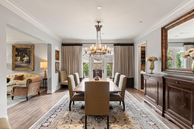 dining area featuring crown molding, light hardwood / wood-style floors, and a wealth of natural light