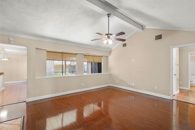 unfurnished room featuring hardwood / wood-style flooring, a textured ceiling, and vaulted ceiling with beams