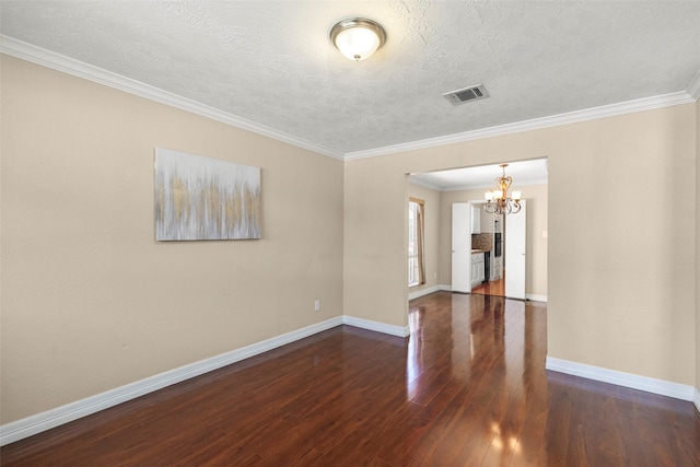 unfurnished room featuring ornamental molding, dark hardwood / wood-style flooring, a textured ceiling, and a notable chandelier