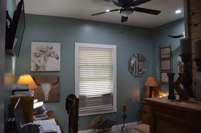 interior space with ceiling fan