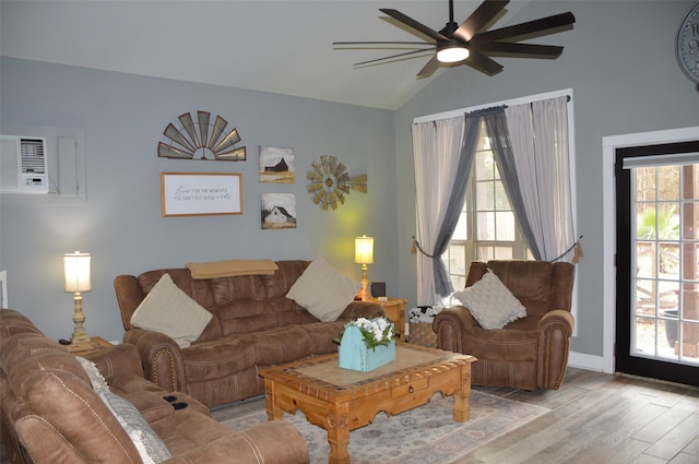 living room with ceiling fan, lofted ceiling, and light hardwood / wood-style floors