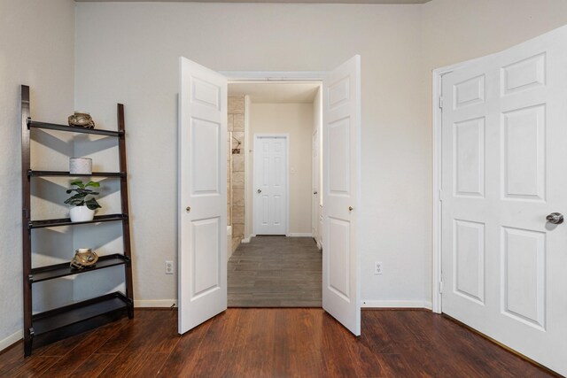 unfurnished bedroom with dark hardwood / wood-style flooring