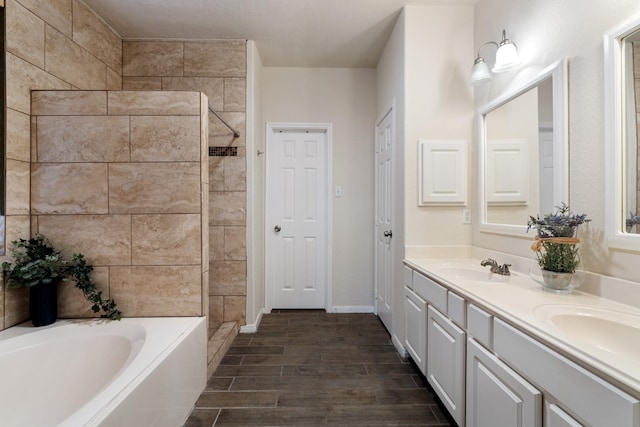 bathroom featuring vanity and independent shower and bath