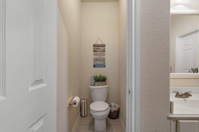 bathroom featuring tile patterned floors, toilet, and vanity