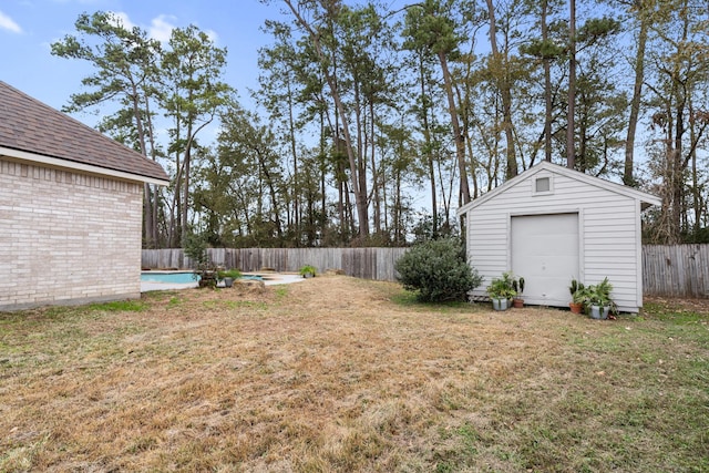 view of yard with a fenced in pool and an outdoor structure