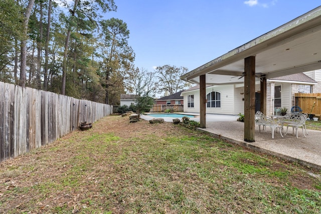 view of yard featuring a fenced in pool, ceiling fan, and a patio area