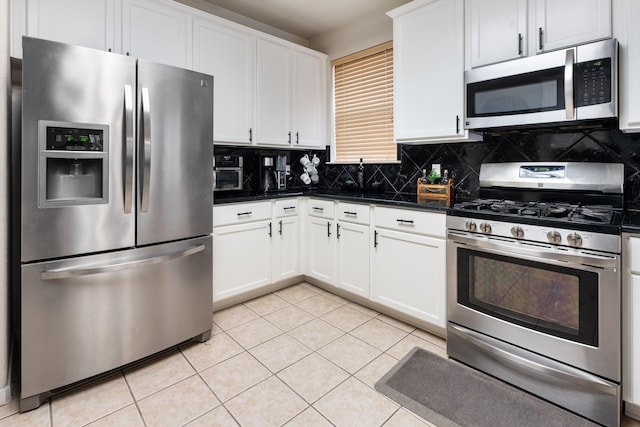 kitchen featuring backsplash, light tile patterned floors, white cabinets, and appliances with stainless steel finishes