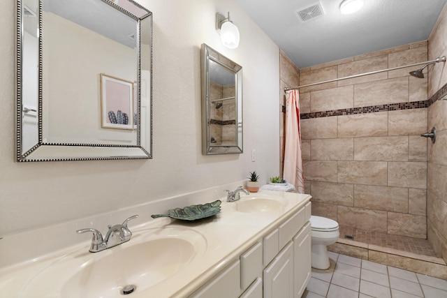 bathroom with vanity, toilet, tile patterned floors, a textured ceiling, and a shower with curtain