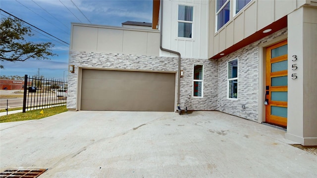 exterior space with concrete driveway and fence