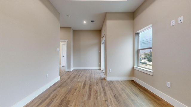 unfurnished room with light wood-type flooring