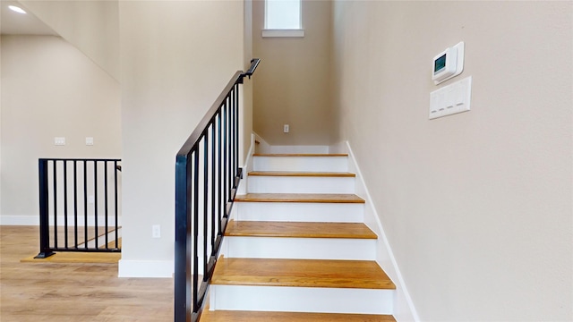 stairway featuring hardwood / wood-style flooring