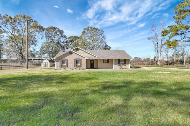 exterior space with a storage shed and a lawn