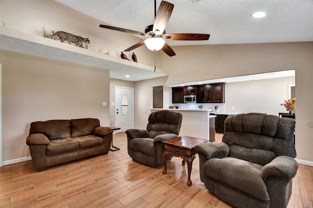 living room with high vaulted ceiling and ceiling fan