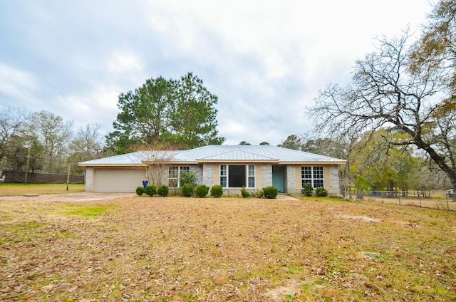 ranch-style home featuring a garage and a front yard