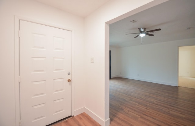 foyer with ceiling fan and dark hardwood / wood-style flooring