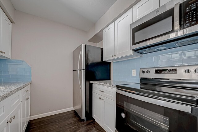 7315 Housman St, Houston, TX 77055 - kitchen featuring stainless steel appliances, dark wood-style floors, baseboards, tasteful backsplash, and white cabinetry