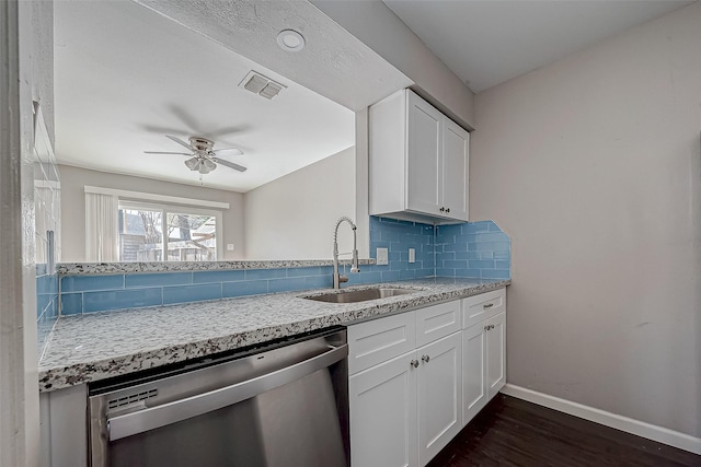 kitchen with tasteful backsplash, dishwasher, sink, white cabinets, and dark wood-type flooring