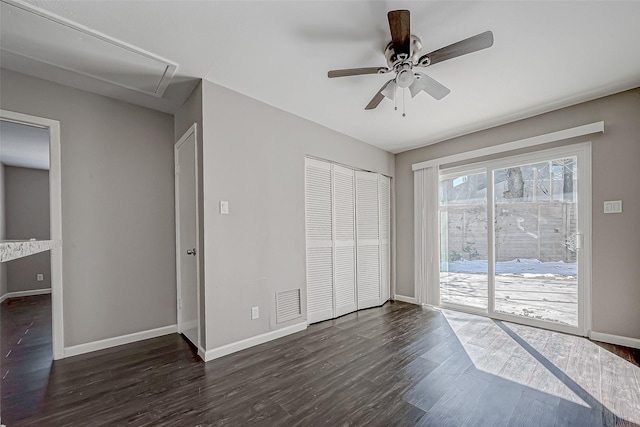 unfurnished bedroom with dark hardwood / wood-style flooring, access to outside, and ceiling fan