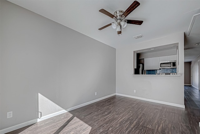 unfurnished living room with ceiling fan and dark hardwood / wood-style flooring