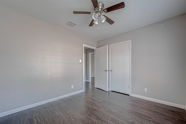 unfurnished bedroom with dark hardwood / wood-style flooring and ceiling fan