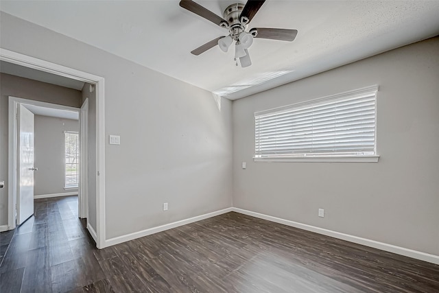 empty room featuring dark hardwood / wood-style flooring and ceiling fan