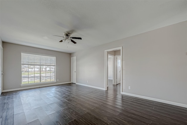 empty room featuring dark hardwood / wood-style flooring and ceiling fan