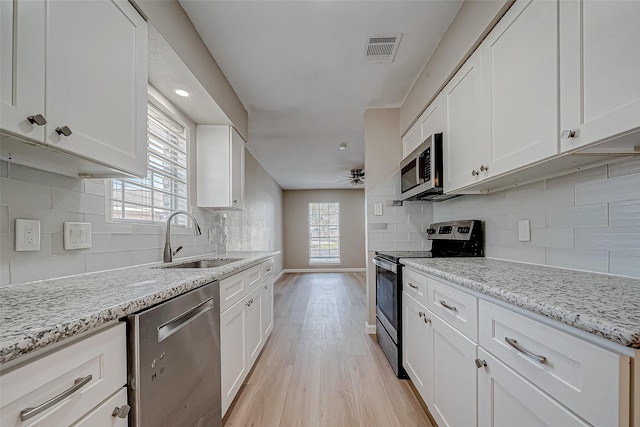 kitchen with white cabinetry, appliances with stainless steel finishes, and sink