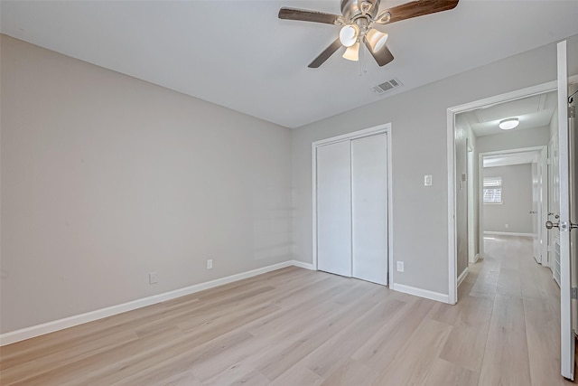 unfurnished bedroom with ceiling fan, a closet, and light hardwood / wood-style flooring