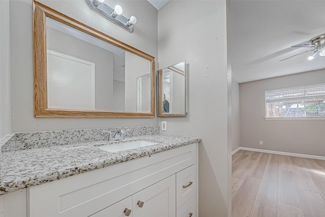 bathroom featuring vanity, hardwood / wood-style flooring, and ceiling fan