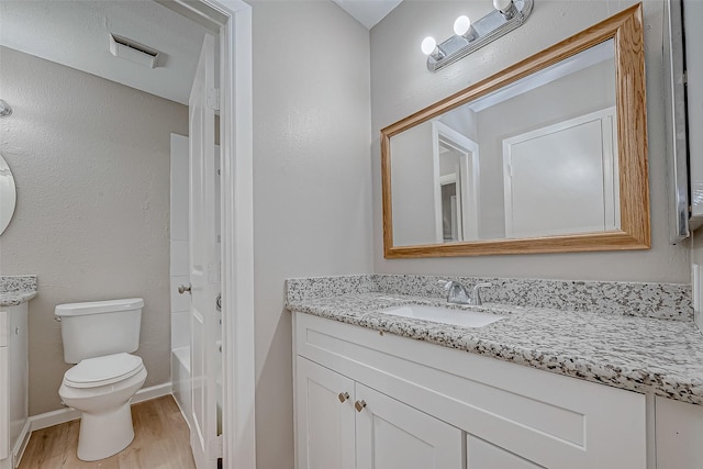 bathroom featuring hardwood / wood-style flooring, vanity, and toilet