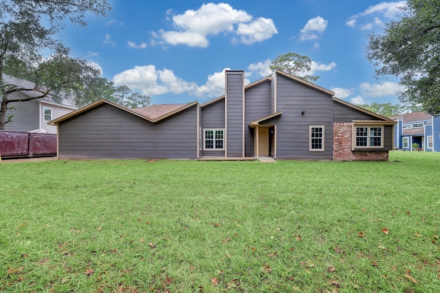 back of house featuring a lawn