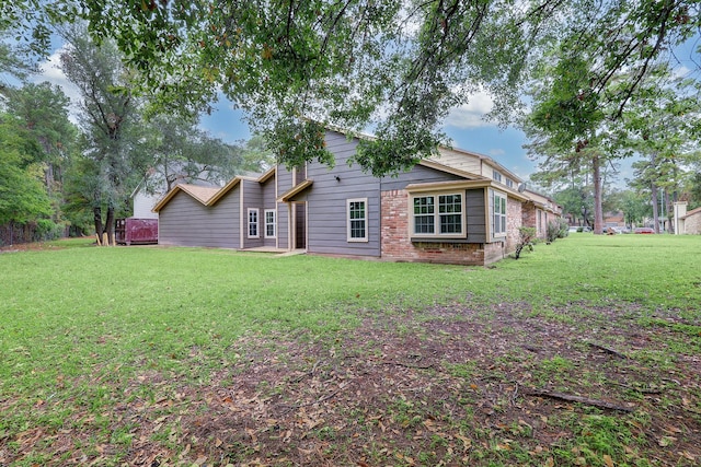 back of house with a lawn