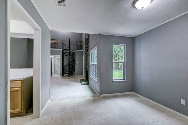 carpeted spare room with a textured ceiling