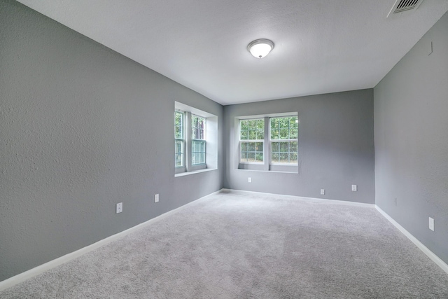 unfurnished room featuring carpet