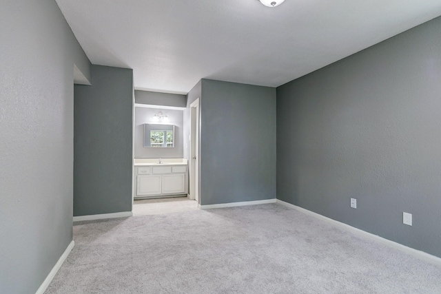 carpeted empty room featuring sink