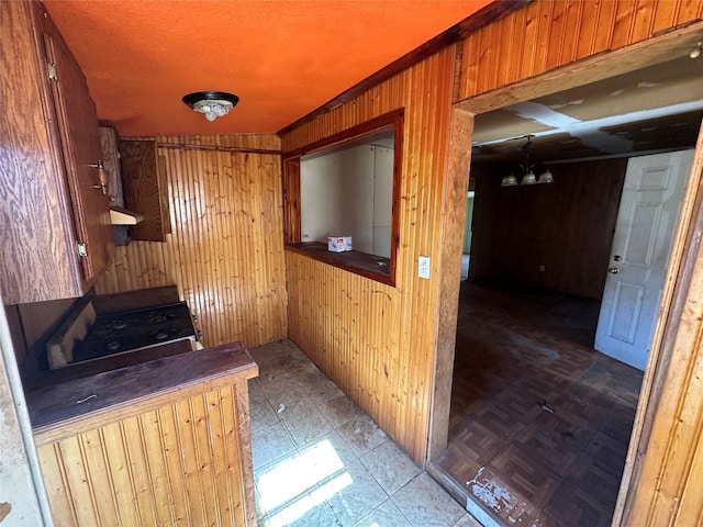 hall with wooden walls and a chandelier