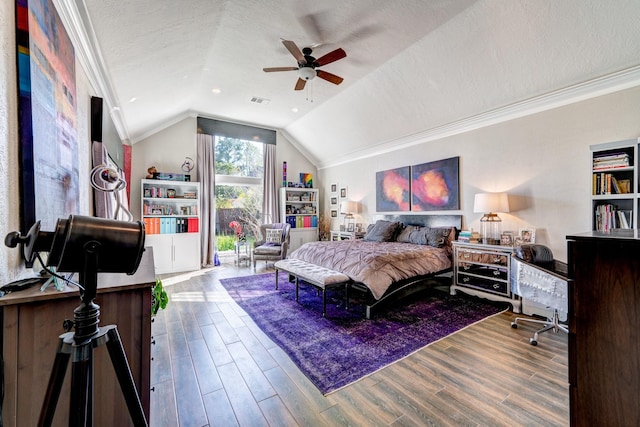 bedroom with crown molding, lofted ceiling, wood-type flooring, and a textured ceiling