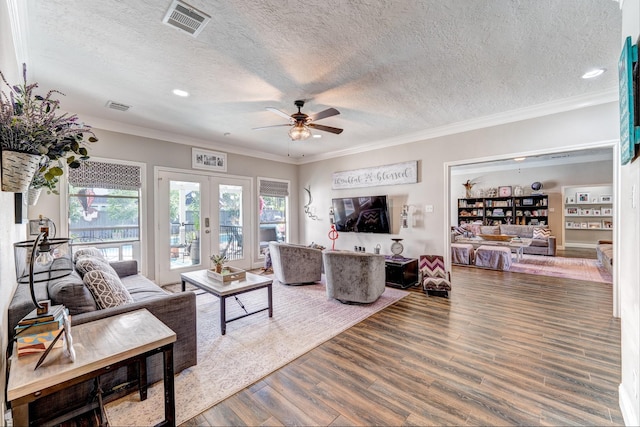 living room with french doors, crown molding, hardwood / wood-style floors, and a textured ceiling